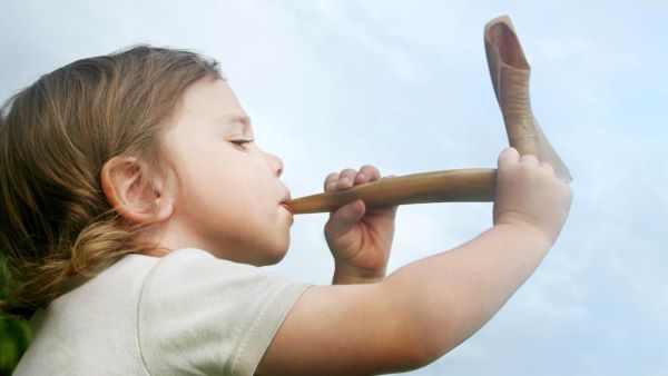 Child blowing a shofar